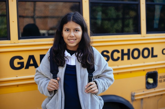 girl hispanic happy near bus
